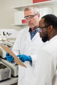 Lab technicians looking over a BioFire® System report.