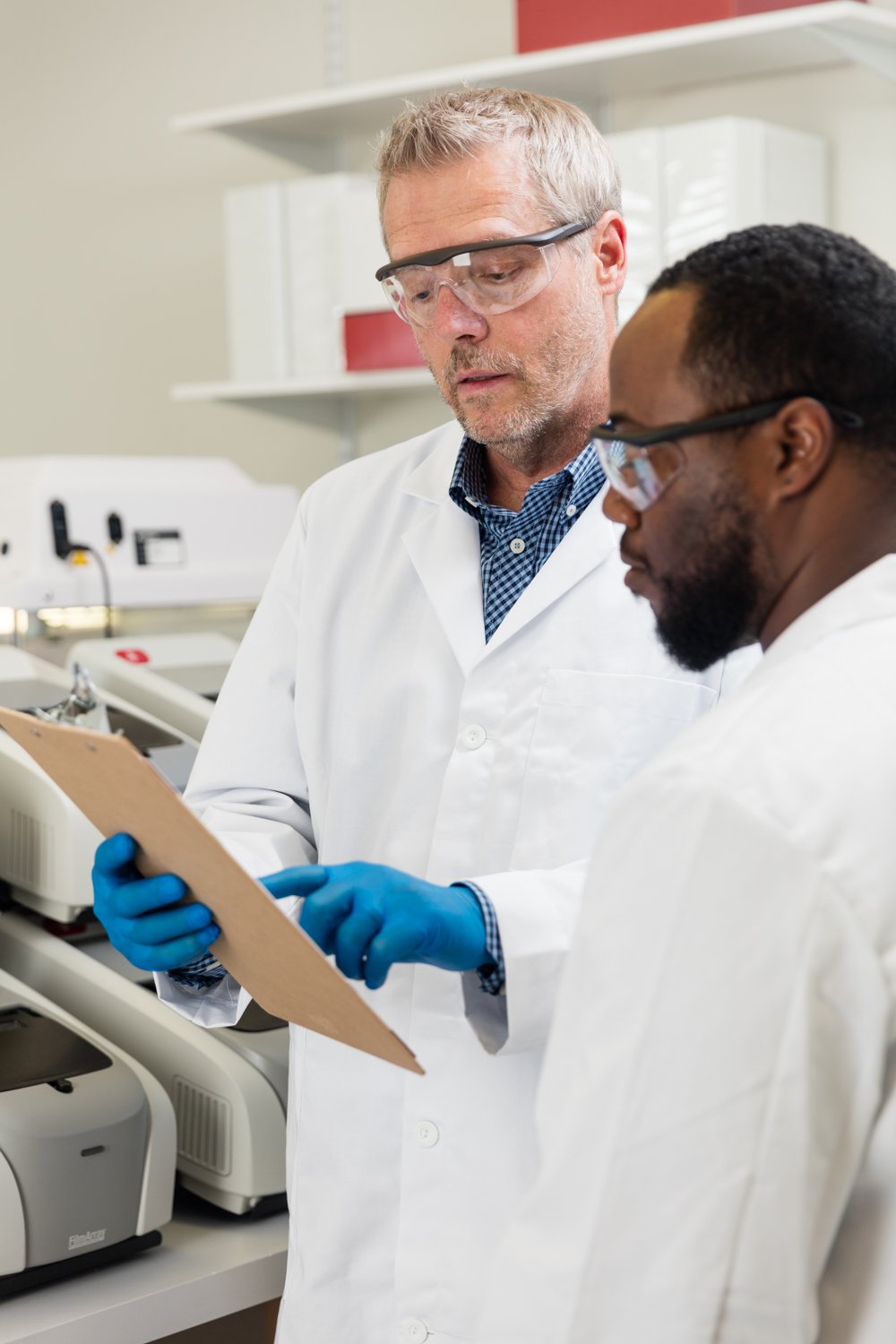 Lab technicians looking over a BioFire® System report.